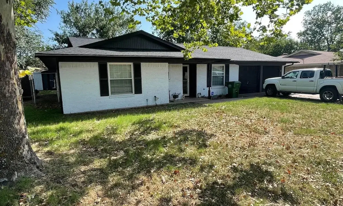 Professional roofing crew working on a residential roof in Gering